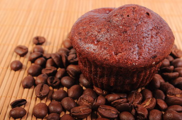 Fresh baked chocolate muffins and coffee grains