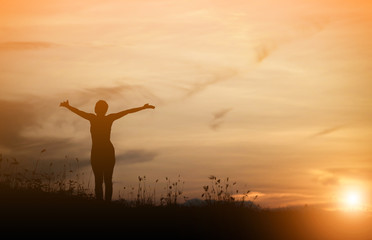 Woman happy at sunset.