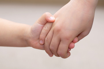 Children hands together holding - childhood friendship concept
