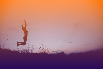 Silhouette woman jumping at sunset