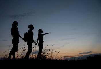 Fototapeta na wymiar Friends holding hands at sunset.