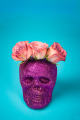 Purple Glitter Skull with Pink Rose Laurel Crown on Blue Background