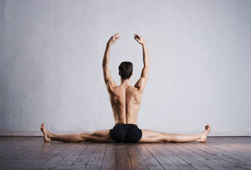 Young and fit modern dancer performing a move