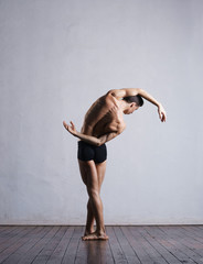 Young and fit modern dancer performing a move