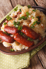 Dutch cuisine: stamppot from potatoes, sauerkraut and carrot close-up. Vertical
