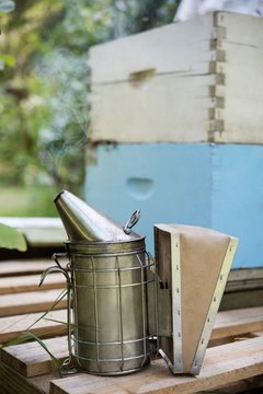 Bee smoker on wooden plank
