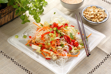 Fresh healthy asian salad with rice noodles and nuts