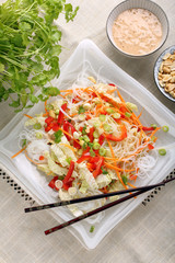 Fresh healthy asian salad with rice noodles and nuts