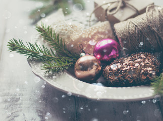 Fir branches, Christmas decorations and snow.Vintage background