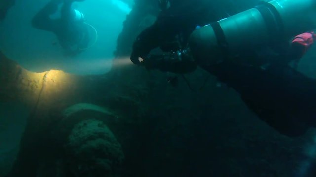 Scuba Divers Inside Shipwreck