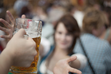 Waitress hands over a beer mug at Oktoberfest