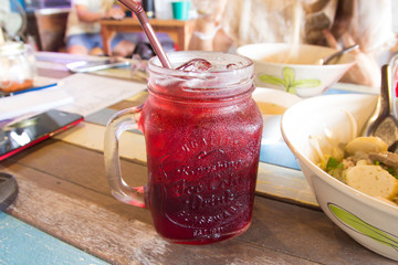Fresh roselle juice on wooden table