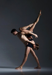 Couple of sporty ballet dancers in art performance.