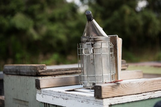 Bee smoker on wooden box