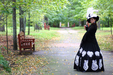 girl eighteenth century dress in park