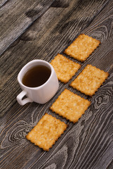 small cup of coffee and cookies on wooden background