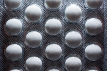 Background in abstract shape, macro photography. Pills packed in