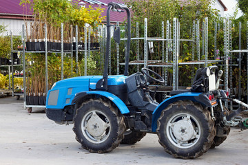 Small tractor in the backyard of nursery for ornamental plants.