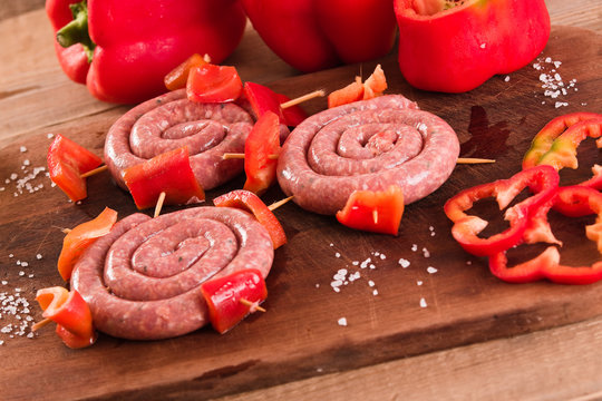 Raw sausage on wooden table. 