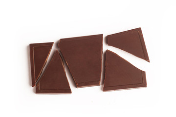 Broken dark chocolate bar on white background
