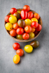 Tomatoes an gray background. Colorful tomatoes, red tomatoes, ye