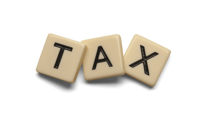 Tax spelled out with lettered tiles on white background. Clipping path included. 