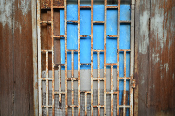 Decorative metal window on an old concrete wall.