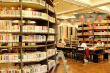 books on bookshelf in library, abstract blur background.Blurred books in public library. Blurred effect. Background.