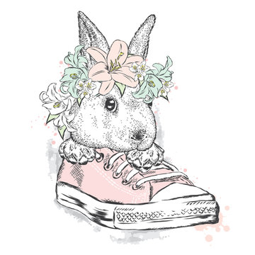 Cute rabbit in a flower wreath. Hare sitting in sneakers. Vector illustration for greeting card, poster, or print on clothes. Fashion & Style.