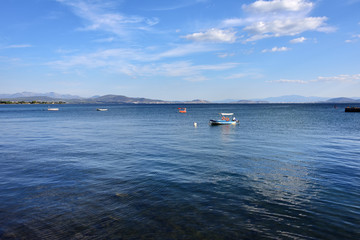 Obraz premium Aegean sea, Xalkida, Greece. Small boats on the azure water