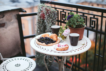 breakfast pastries with tea and grapes on the balcony overlooking the city