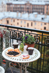 breakfast pastries with tea and grapes on the balcony overlooking the city