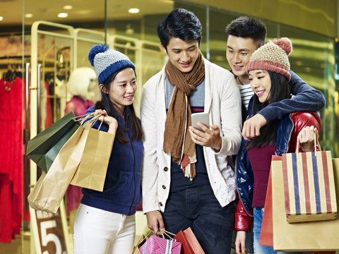 young asian couples enjoying shopping in mall
