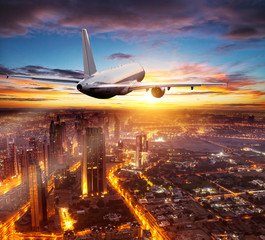 Commercial airplane flying over Dubai city