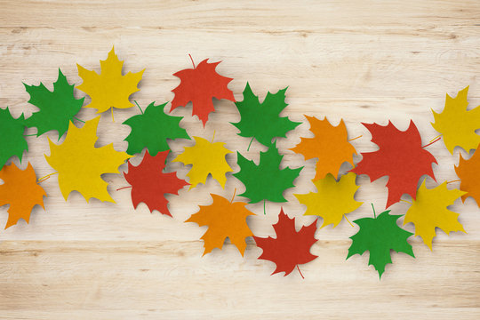 thanksgiving day concept with 3d rendered colourful maples on wooden background