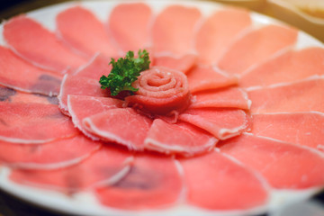 Fresh pork slice for shabu or sukiyaki on circle dish - Japanese food, raw food