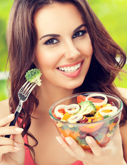 brunette woman with vegetarian vegetable salad