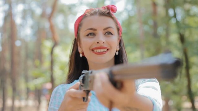 Pin up woman hold gun in her hands
