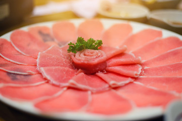 Fresh pork slice for shabu or sukiyaki on circle dish - Japanese food, raw food