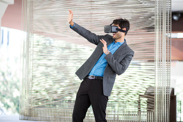 Elegant Young Businessman Using VR Headset