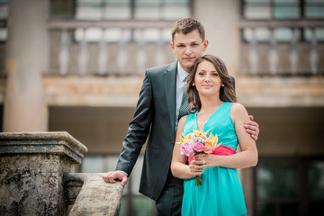 groomsman and bridesmaid near stairs castle