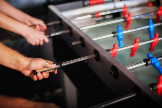 Friends Having Fun Playing Table Foosball