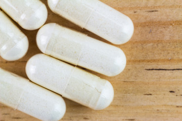Food supplement pills, glucosamine capsules, macro image, top view