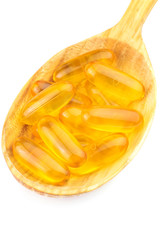Full spoon of fatty acid, omega 3 capsules isolated on white background.