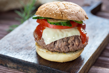 Delicious hamburger served on wooden planks