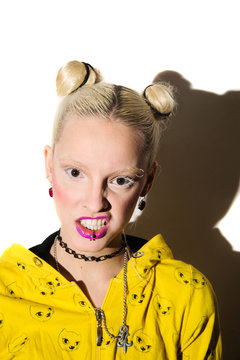 portrait of a beautiful freak angry albino girl in a yellow jacket with pink lips against a white wall