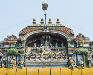 Fototapeta premium The sculpture of Vishnu with Lakshmi and other gods on one of the walls of the temple complex is Shriranganath XVI century in Trichy, South India.
