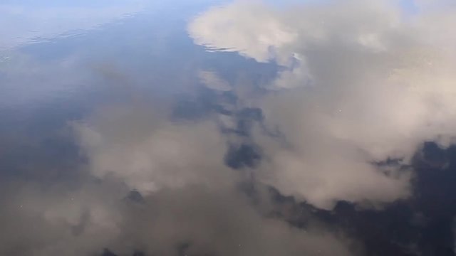Artistic cloudy sky reflection in the water.