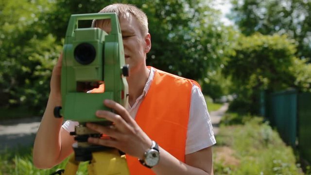Surveyor at work measuring the distance