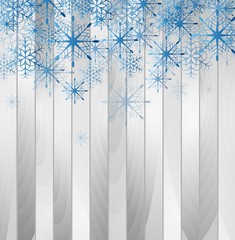 Blue falling snowflakes on wooden background